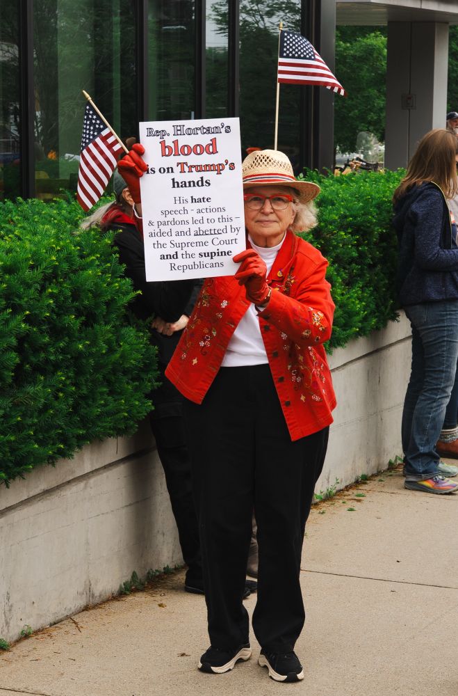 Sign that says, “Rep Hortons blood is on trump’s hands. His hate speech -actions & pardons led to this - aided and abetted by the Supreme Court and the supine Republicans.”