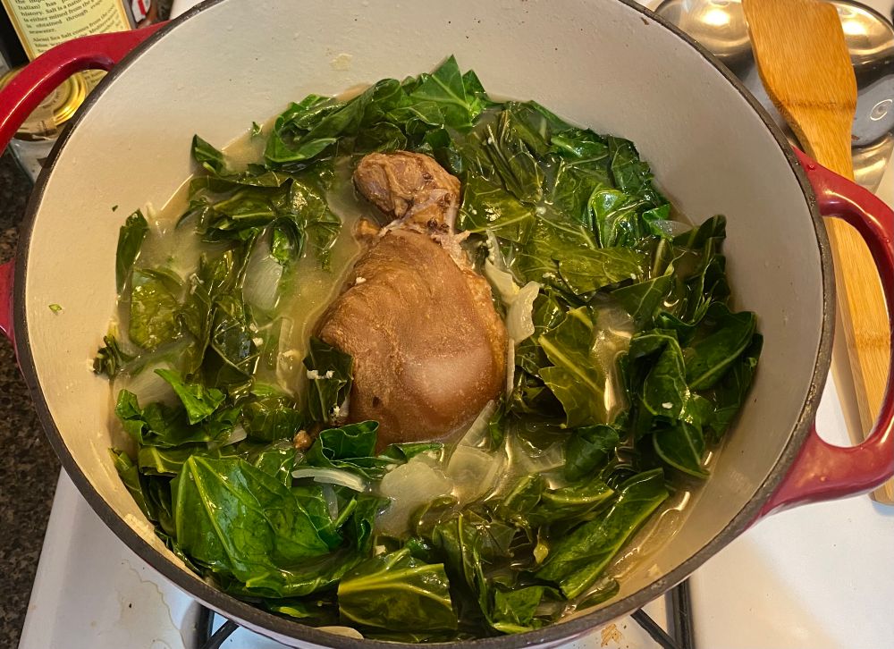 Collards in a pot with a ham hock