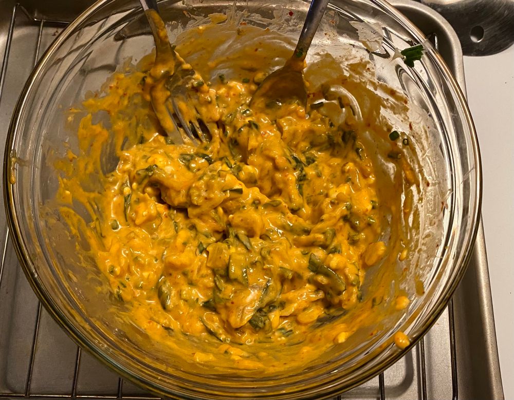 A bowl of different cheeses & kimchi mixed together 