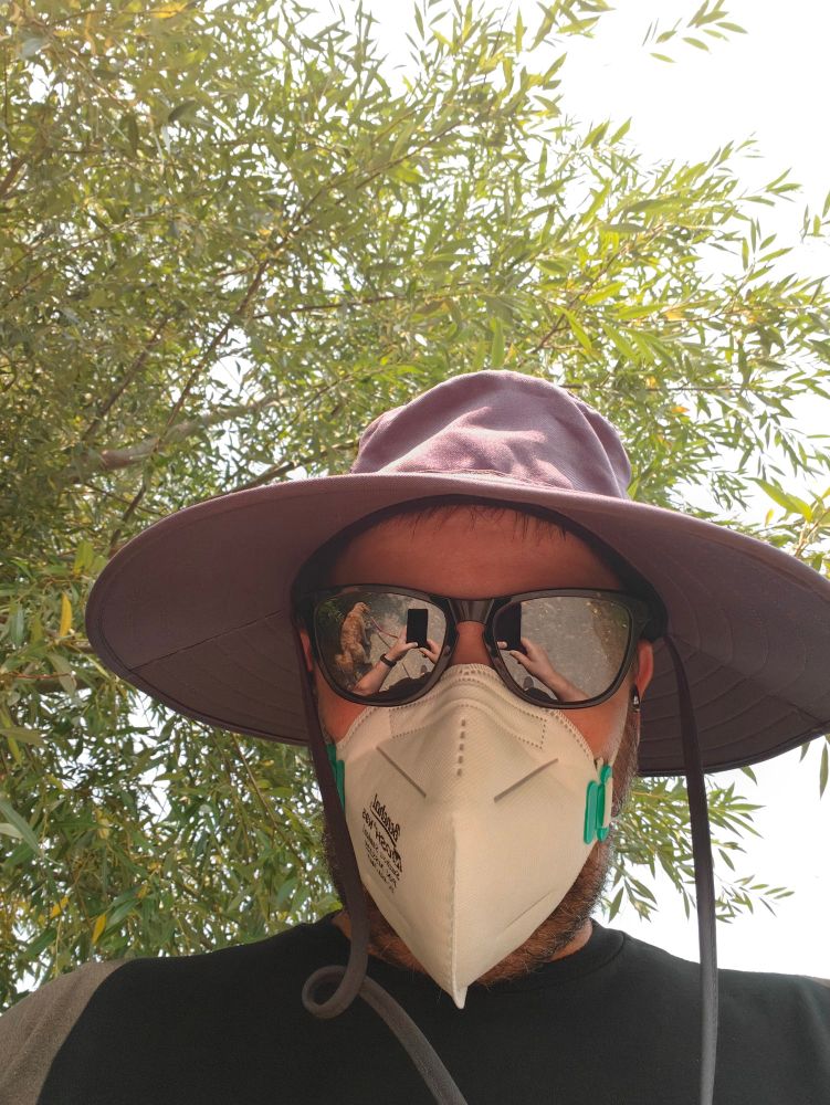 Giant hat, sunglasses, n95 mask resembles plague doctor gear
