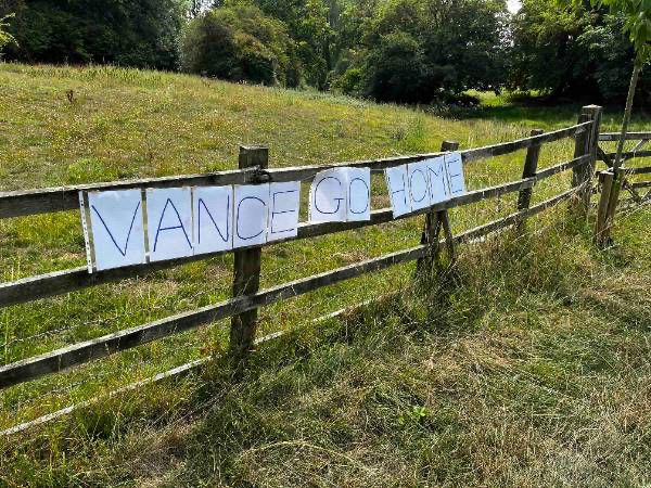 Placard in Dean reading "Vance go home"