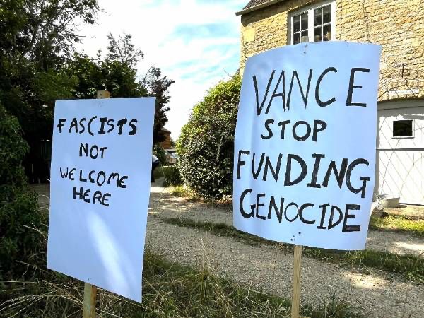 Placards in Dean reading "Fascists not welcome here" and "Vance stop funding genocide"