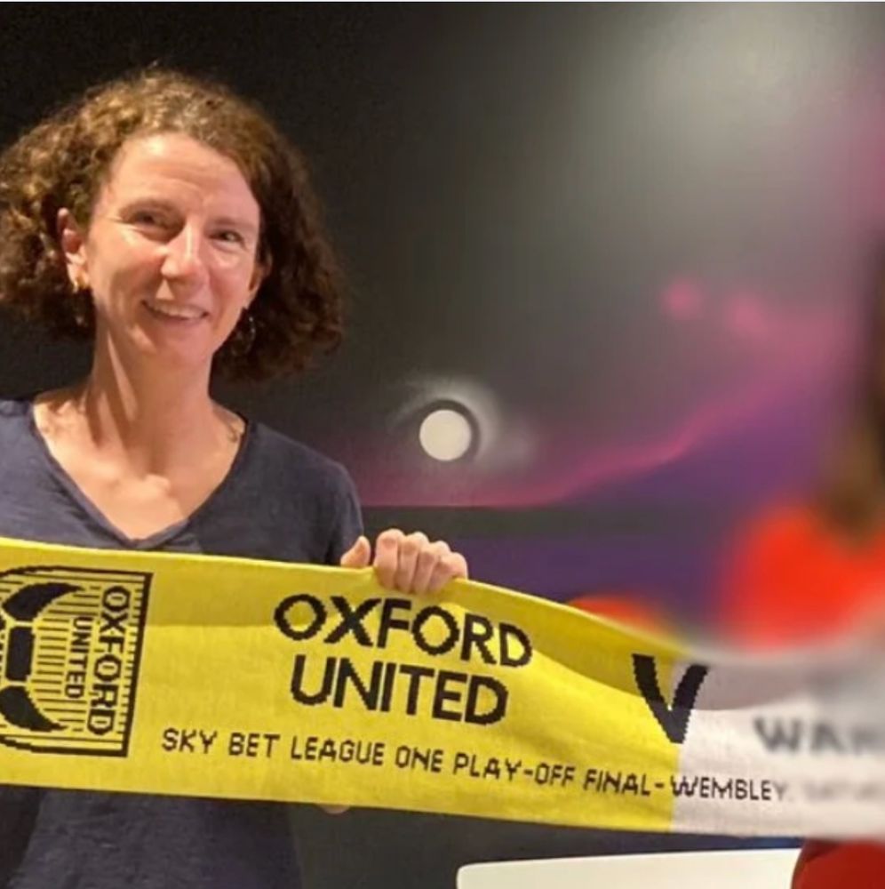 Anneliese Dodds MP holding a yellow Oxford United scarf.
