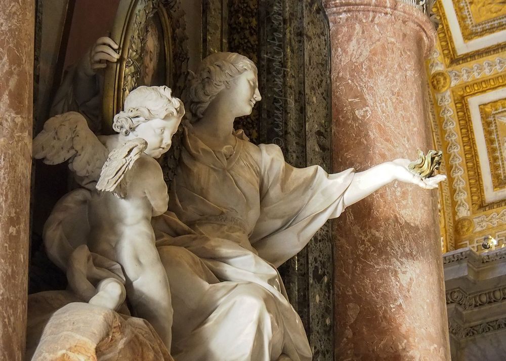 This image shows the hand belongs to a woman, who holds a portrait of the deceased in her other hand, and has a cherub to her left.