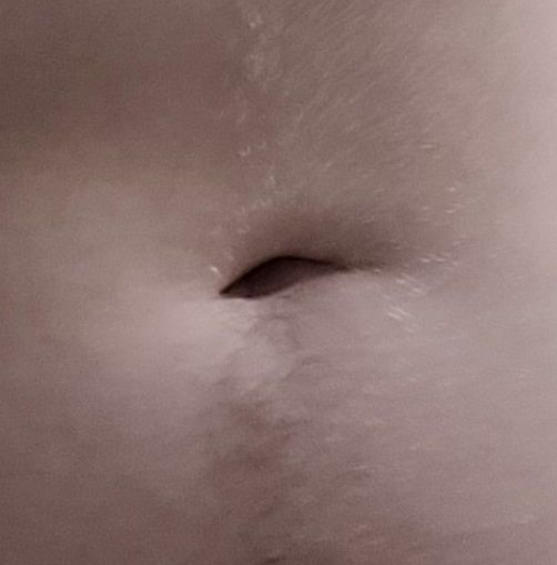 a belly button with some hair around it