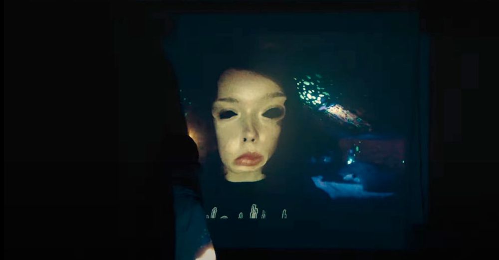 A still from We're All Going To The World's Fair, showing a teenager with a distorted face.