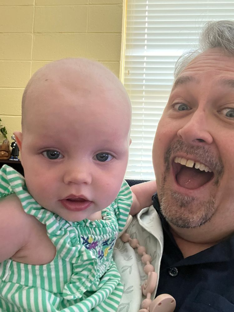 My coworker’s granddaughter hanging out with me at work and joining me in a photo.