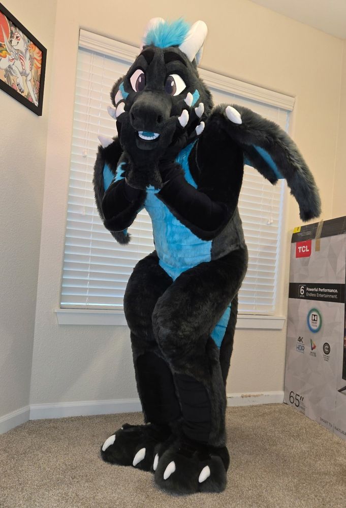 Dragon fursuit looking at you cutely.