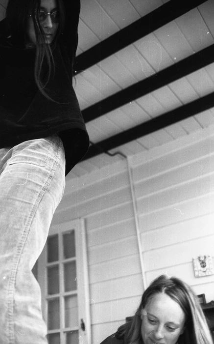 📷 Max Oettli
I have started to explore the 3000 odd photographs of Max Oettli that are held at the National Library of New Zealand. Here we have a photograph of two women. The photographer is probably sitting back from a table we can't see . In the right hand corner we see the head of a woman looking down as if reading or writing then, to her right, taking up all the left edge of the photograph another woman is standing presumably on the table. Her pose is almost dance-like but difficult to understand. She could be changing a lightbulb except she is looking down at the other woman. It's not clear if they are in a room or outside under an awning. 