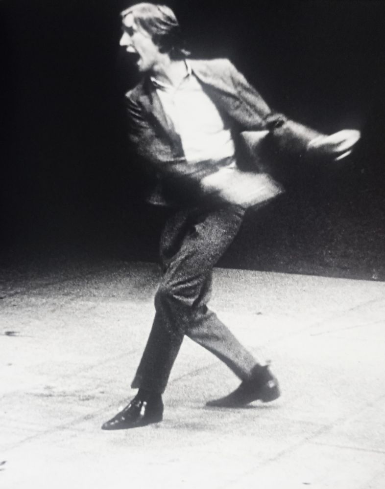 📷 Snowdon 
A second blur black & white photograph of Denis Waterman in Saved. This is a double page spread in my book. I've just photographed the right page. On the left is a pram. If my memory serves the pram with baby gets chucked off the stage, here he seems to be doing the chucking, his upper body, hands in particular, are blurred, but when I look at the whole piece the pram is clearly stationary. But anyway it's one of his blurs.