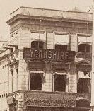 Detail from the photograph of the commercial district in Istanbul in the quoted post showing a board on a building with 'YORKSHIRE' written on it, but can't make out what it says just either side on the same board.