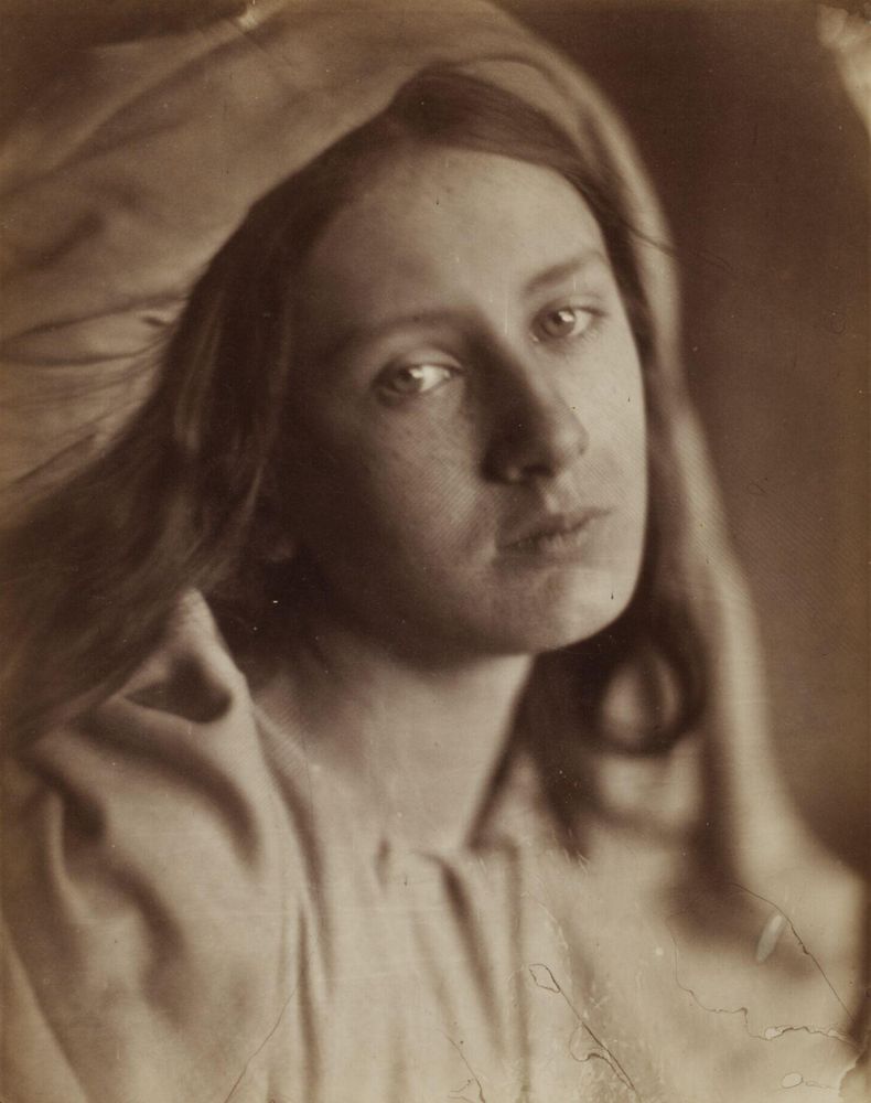 📷 Julia Margaret Cameron 
Albumen print, brown tones, of May Prinsep looking tragic. Close-up, head and shoulders, head tilted towards the camera, eyes looking around the camera, wearing white robes including over her head concealing much of her hair.

This to accompany the text from Katherine Mansfield, Taking the Veil.