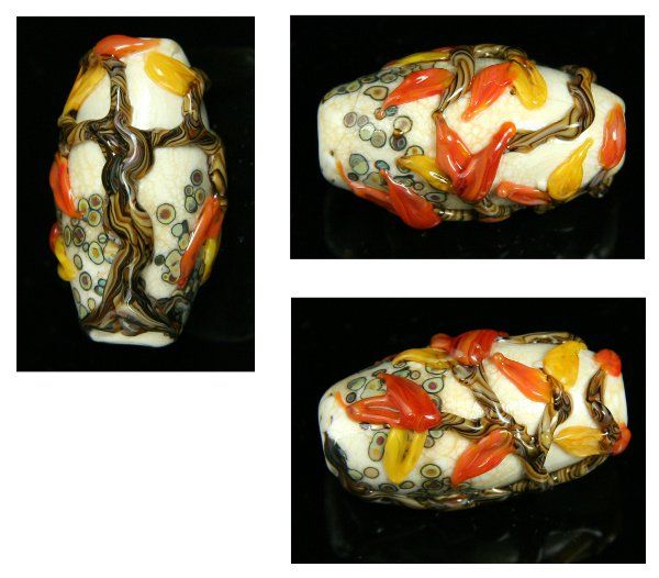 A large oval glass bead seen from three angles. The base is ivory colored with some multicolored speckles in brown and green. On top of the base is a tree trunk with branches in 3D, striped in dark and light brown colors, and orange and yellow leaves that are shaped rather like flames.