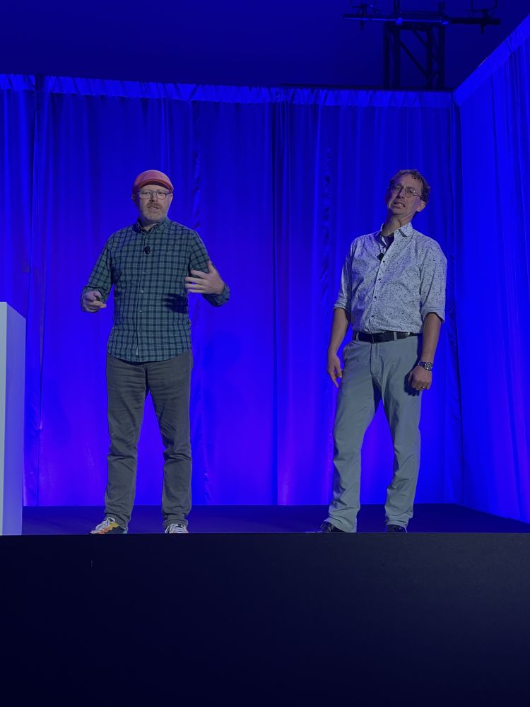 On stage at MS Ignite, Andy, looking like an intelligible human, and Vincent, looking like a Muppet with a grimace