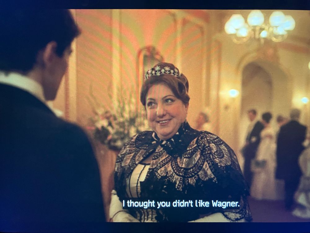 A scene from Season 3, Episode 8 of The Gilded Age. Mamie Fish (Ashlie Atkinson) is saying “I thought you didn’t like Wagner.”