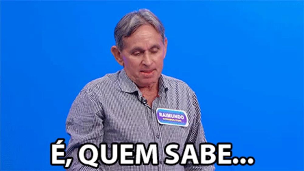 a man with a name tag that says raimundo stands in front of a blue background