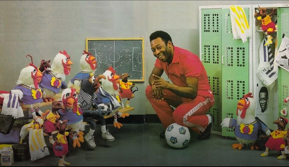 Pelé poses with a group of Muppets as if he’s their coach. 