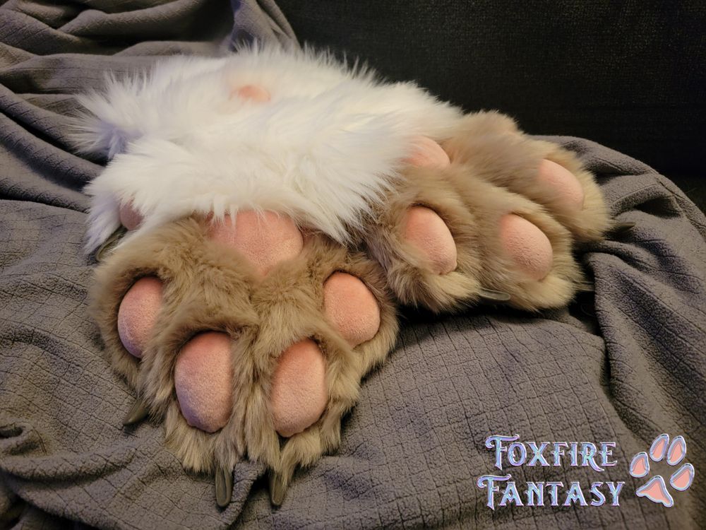 A pair of handmade plush realistic handpaws with white fur and tan fingers, and dusty pink pawpads. 