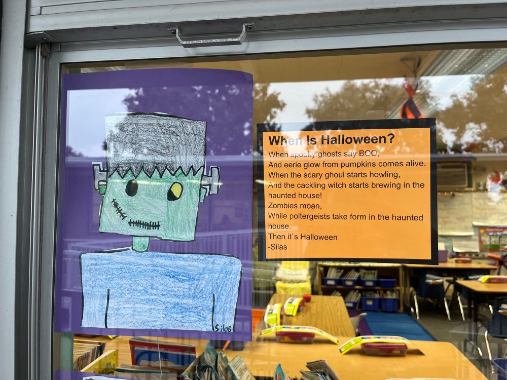 A kid’s drawing of a Frankenstein monster in green, on a purple background; then a poem that reads:

When Is Halloween?
When spooky ghosts say BOO,
And eerie glow from pumpkins comes alive.
When the scary ghoul starts howling, And the cackling witch starts brewing in the haunted house!
Zombies moan,
While poltergeists take form in the haunted house.
Then it's Halloween
-Silas