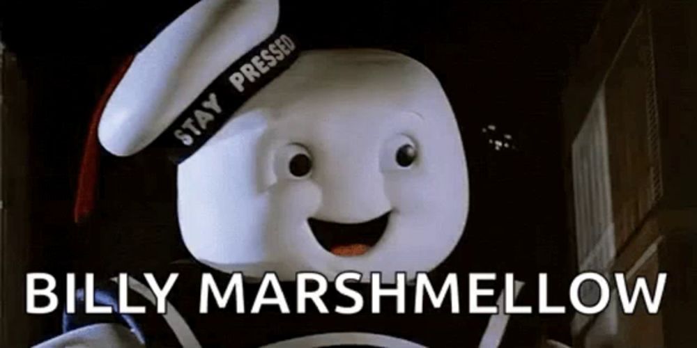 billy marshmallow from the movie stay puft marshmallow is wearing a sailor hat and holding a marshmallow .