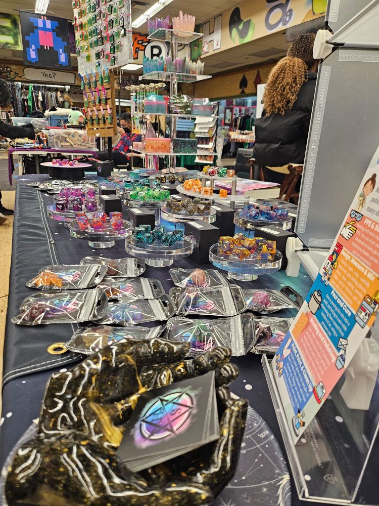 A very sparkly booth full of resin dice and jewelry on display at a flea market type event 