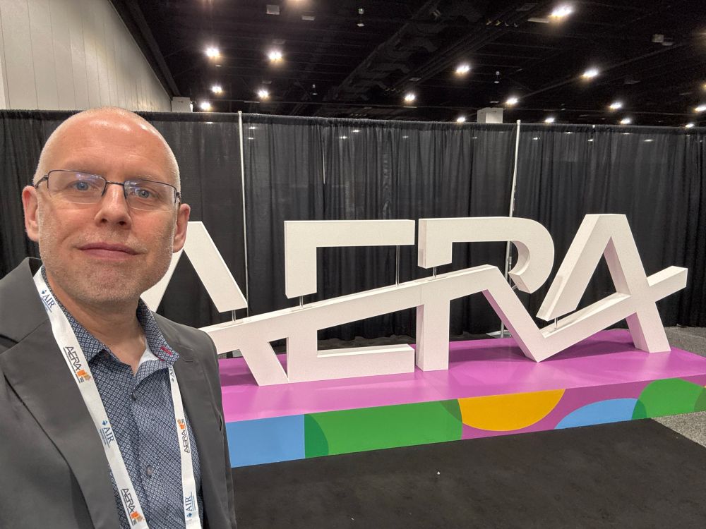 Me in front of a big sign that says AERA