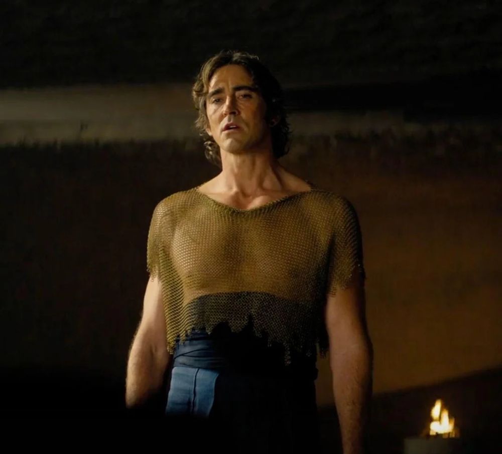 Lee Pace wearing future fashion, which appears to be a long blue skirt and a mesh top that shows his nipples.