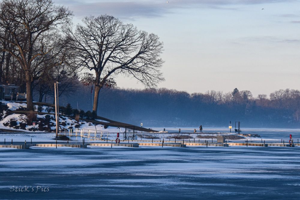Fog rising from a frozen lake.