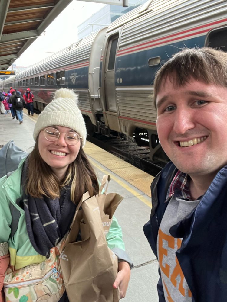 Selfie of Ed and Alice standing alongside the train at Washington Union Station