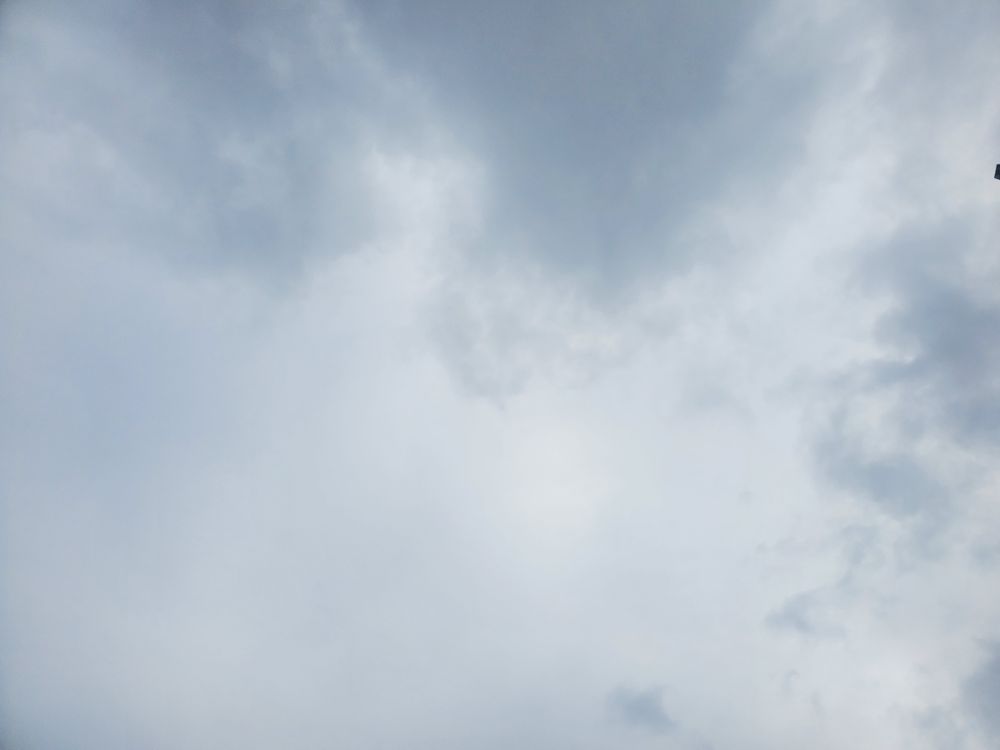 A grey and white cloudy sky, taken today. It rained about an hour later.