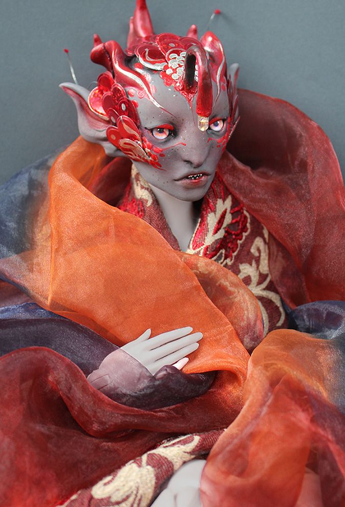 a doll with fins on its head, sharp little teeth, and the light-up forehead antenna of an anglerfish.