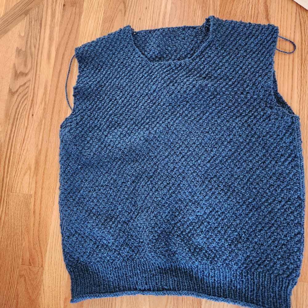 Just finished 3 needle bind off on shoulders on blue moss stitch sweater. 