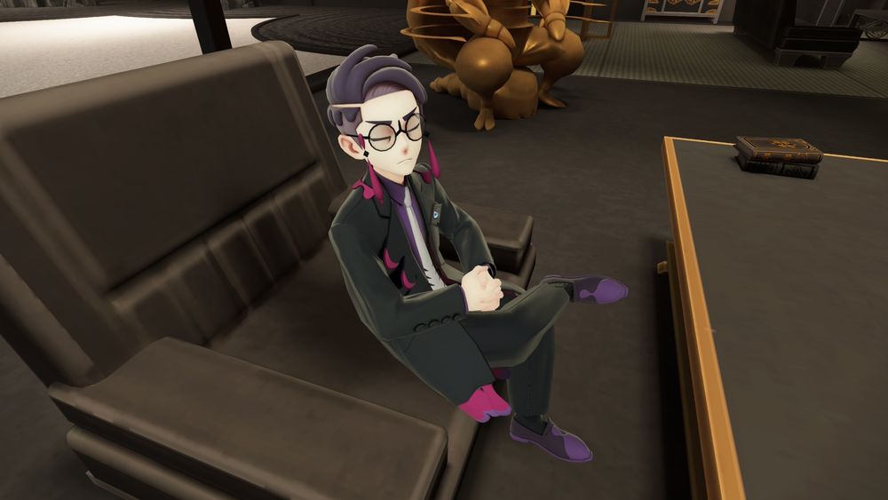 Corbeau sits in his chair in his office, being cute. He's the same height as the player character