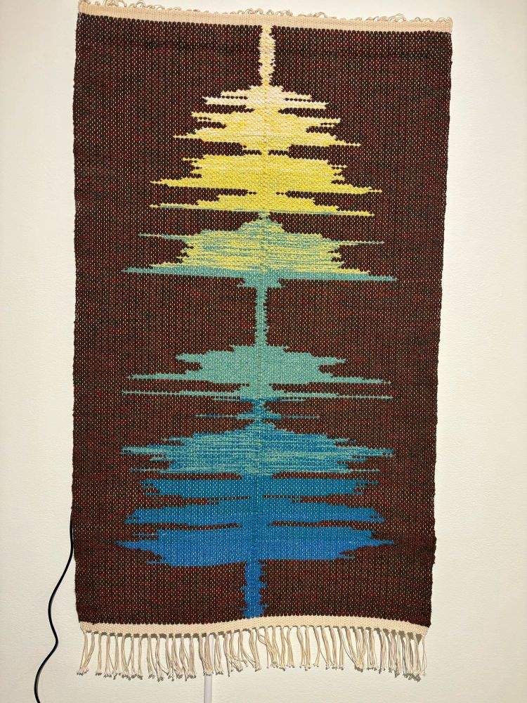 Brown prayer rug with vertical voiceprint, using palette of yellows, blues, and whites. 

“Unable are the love to die, for love is immortality.” Emily Dickinson