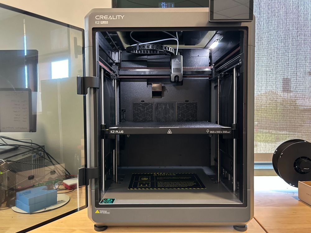 Creality K2 Plus with its door opened.