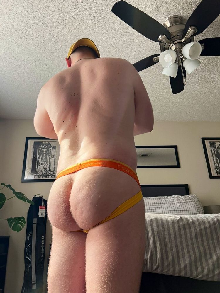 Poster posing for a nude photo showing his back and butt with a jockstrap