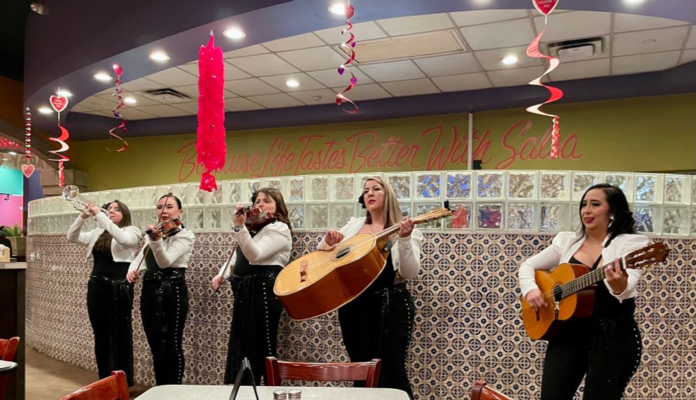 Women mariachis performing with their musical instruments