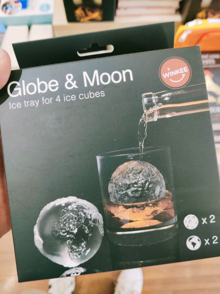 Ice tray for ice cubes shaped like earth and moon.