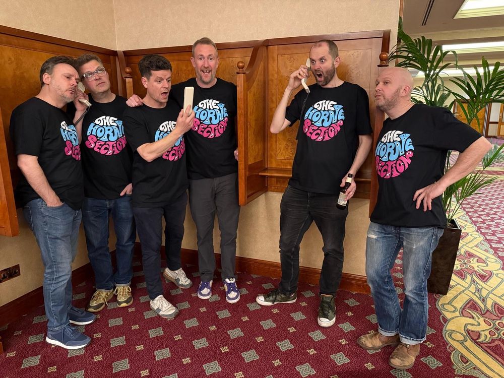 All six members of the Horne Section wearing the new t-shirt merch.