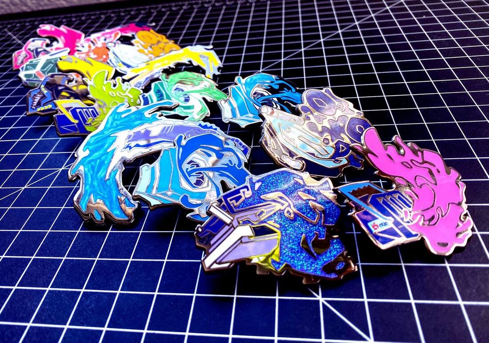 a picture of the version 1 Splatoon weapon pins by BUGSLAP