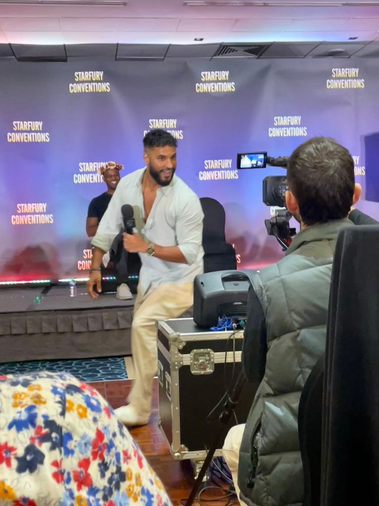 Ricky Whittle off stage and playing up to the camera 