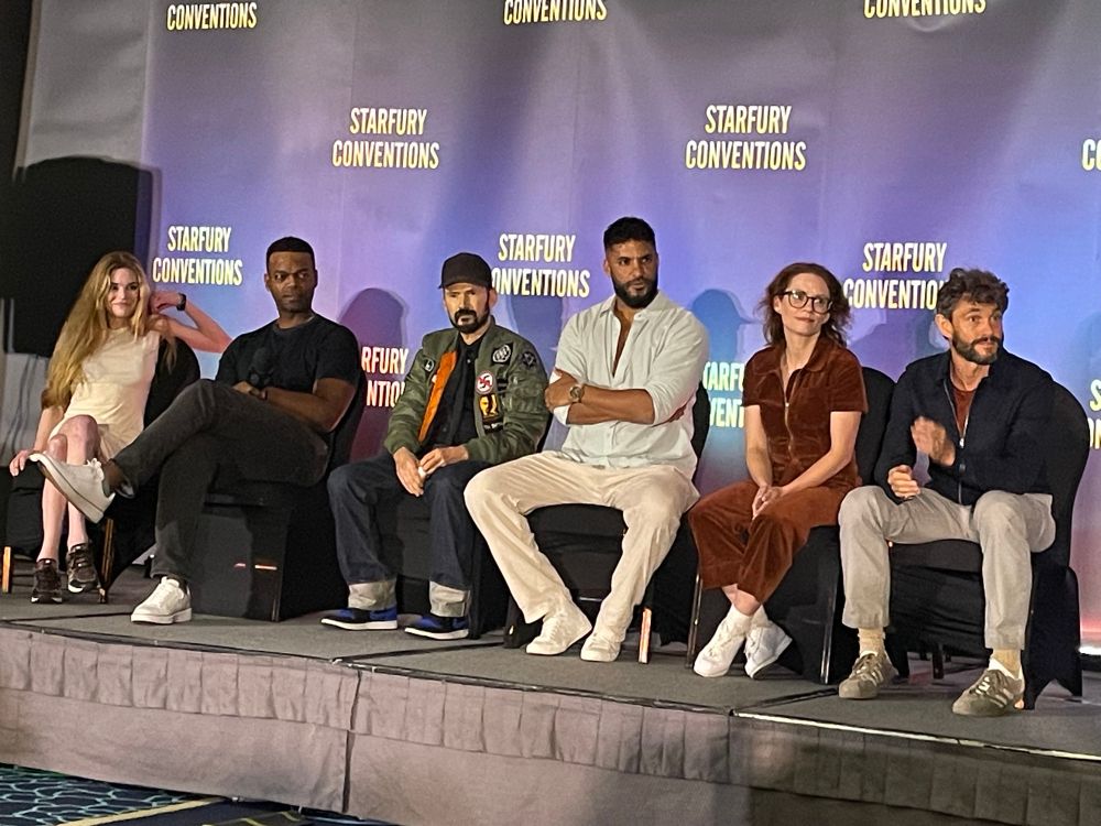 All the guests seated on stage with the Starfury backdrop