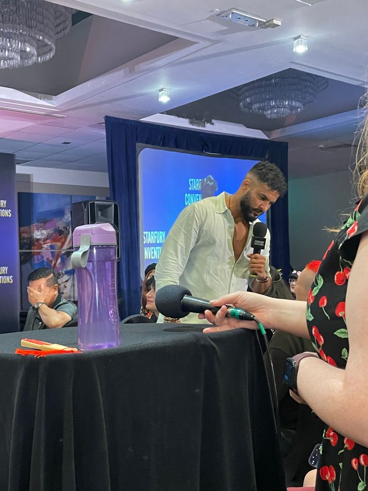 Ricky Whittle interacting with the audience, making hard eye contact with someone
