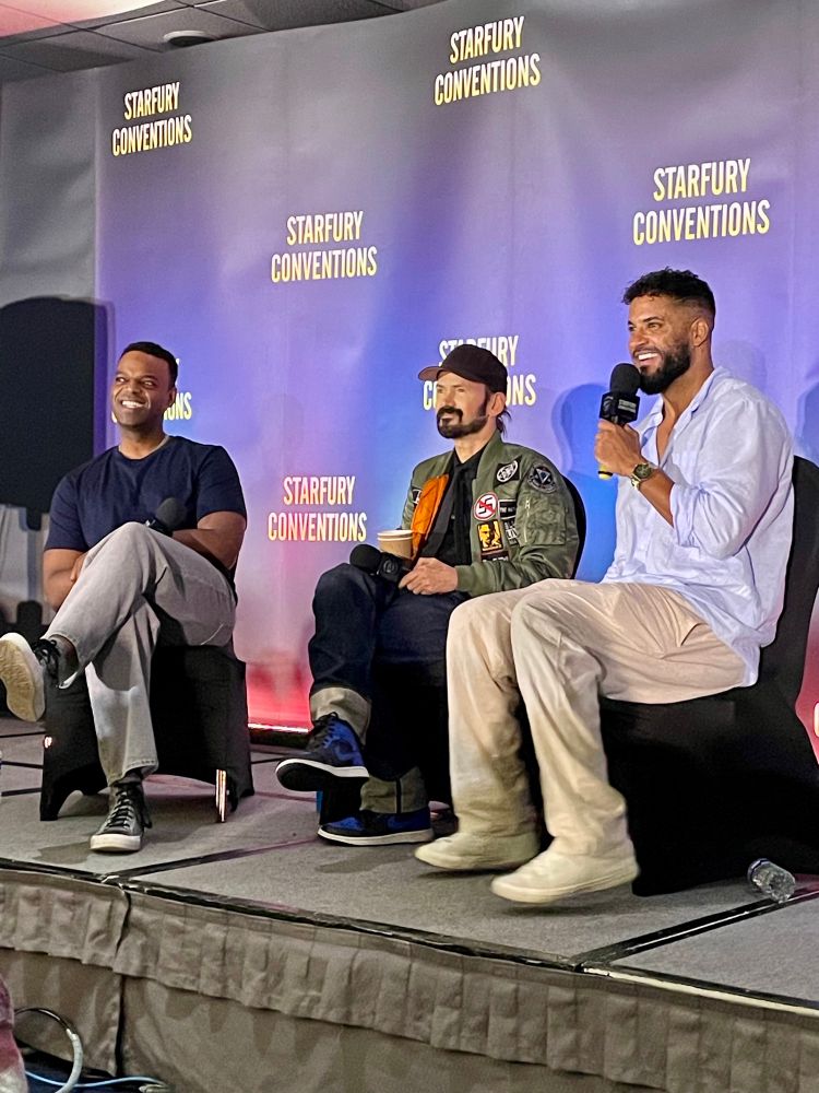 Demore Barnes, Jeremy Davies and Ricky Whittle seated on stage 