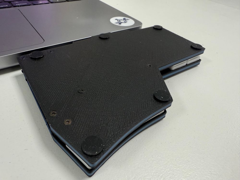 Photo of the keyboard halves stacked on top of each other, showing they are the same height as a MacBook Pro (without its lid down!)