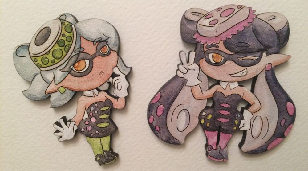 Laser-cut and watercoloured cutouts of chibi Marie and Callie.