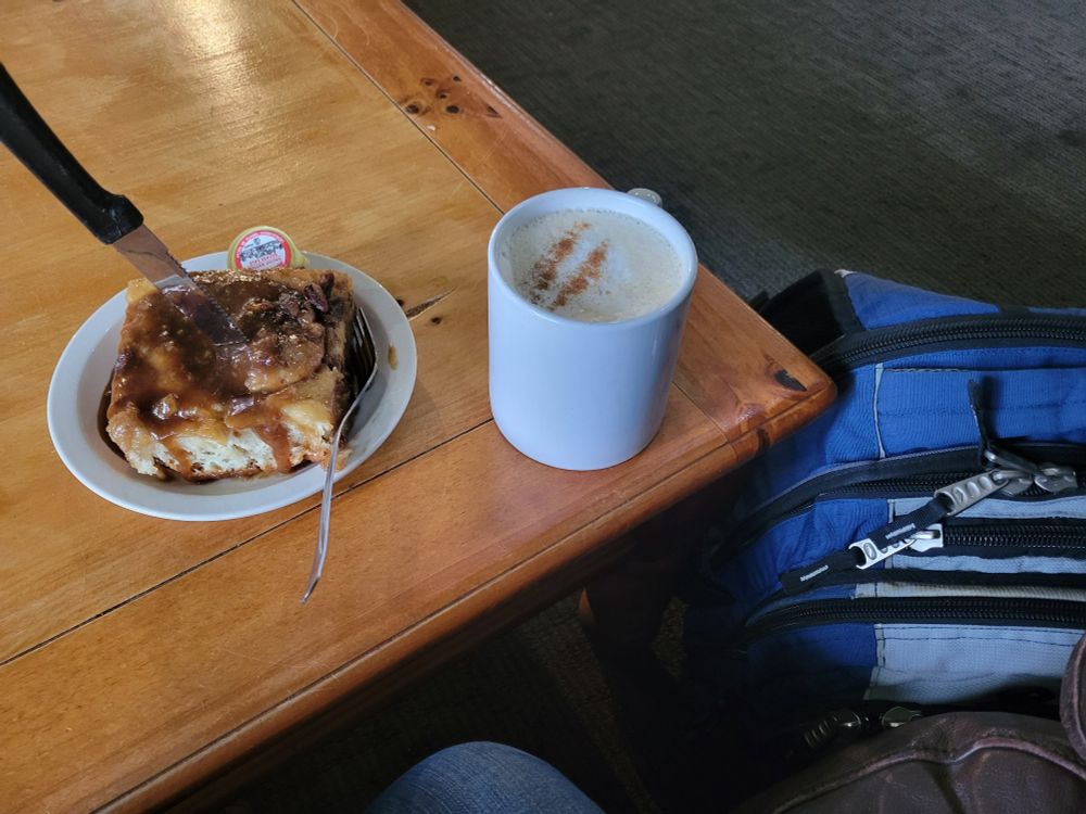 A very large cinnamon bun, chai latte and an old blue med school backpack)