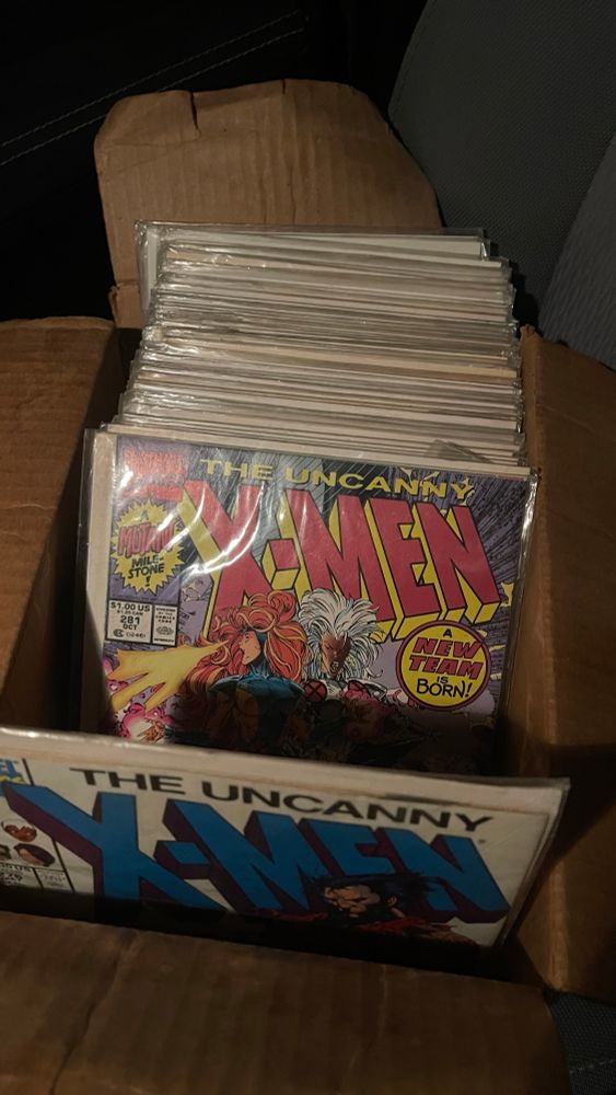 a box containing a large stack of 90’s X-Men comcis