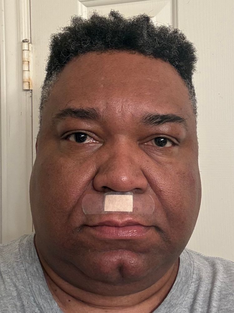 Hot mature man with a band aid above his lip