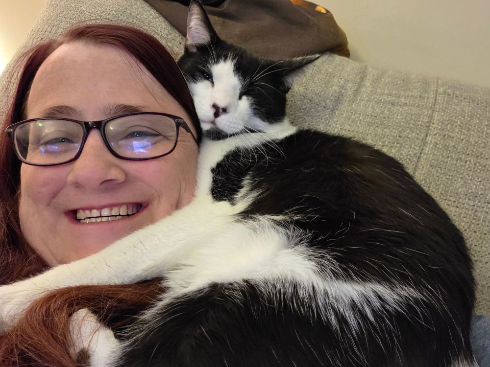 Katie with a black and white cat named MooCow
